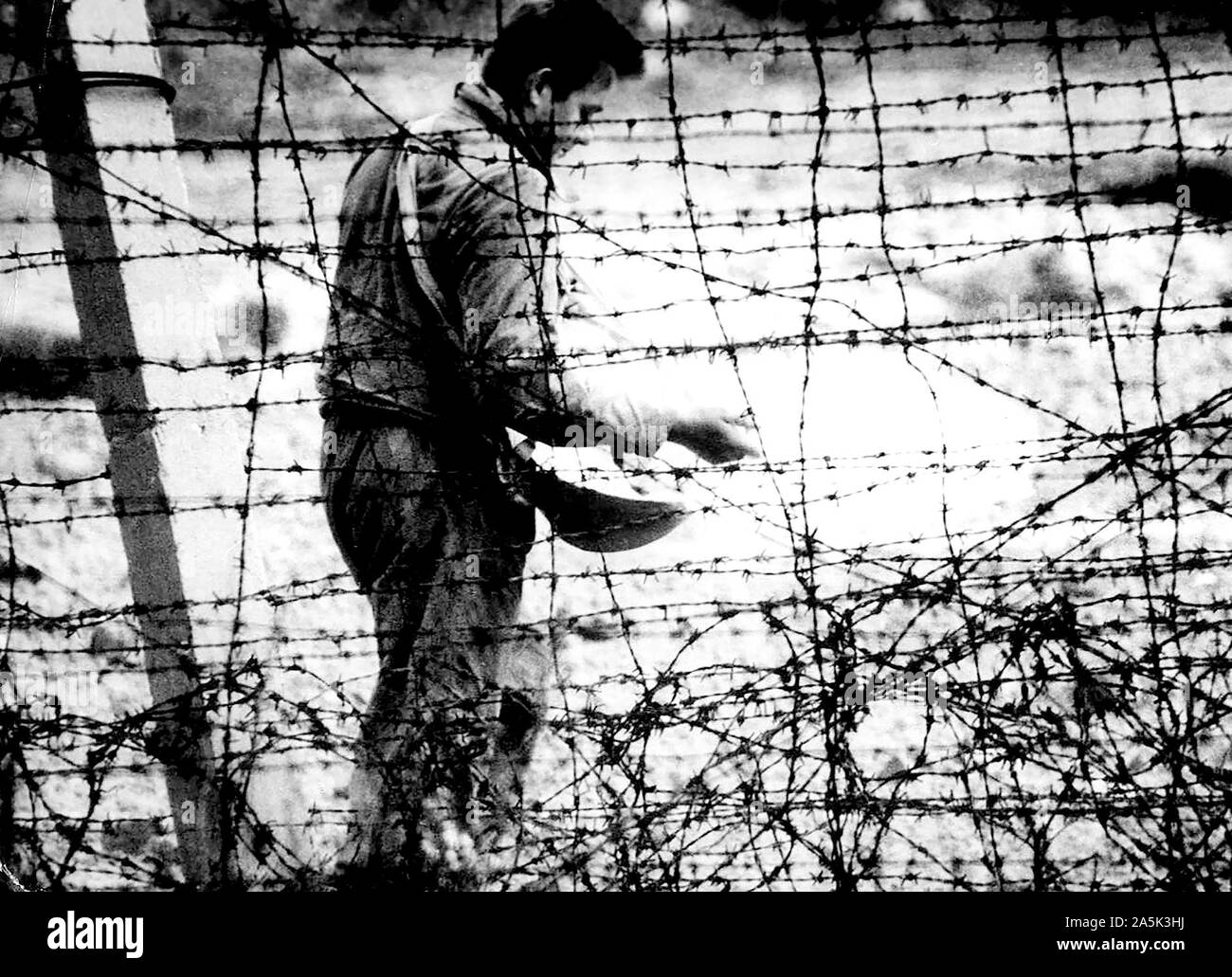 'Death Strip' Although He Resembles A Farmer Sowing Seed, This East German Workman Is Sprinkling Chemicals to Kill Weeds in the 'Death Strip' Along The Communist Built Wall In East Berlin Stock Photo