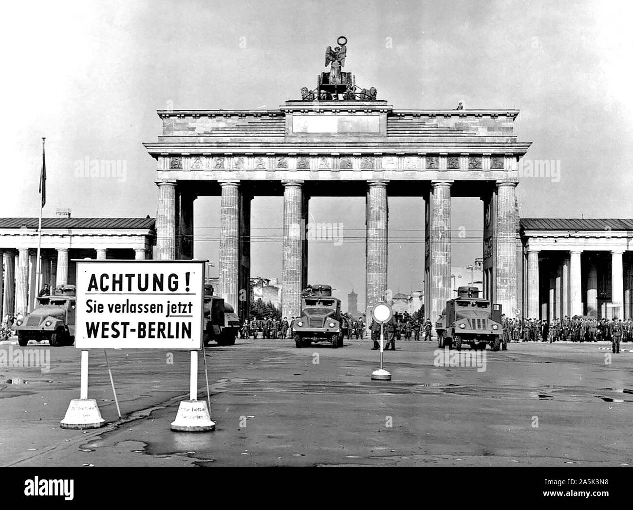 Original caption: East Berlin Put Behind Iron Curtain  Berlin, August 1961 - In a final attempt to halt a flood of refugees escaping from East Germany through West Berlin, the Communist Government of the Soviet Zone moved on August 13th to block off East Berlin with troops, road blocks and barbed wire. Heavily armed East German forces, backed up by Soviet army units, patrolled the East Sector to prevent disturbances while the free West Berliners, angered by the Communist action, demonstrated on their side of the border in sympathy with those now cut off from any contact with the West.  Militar Stock Photo