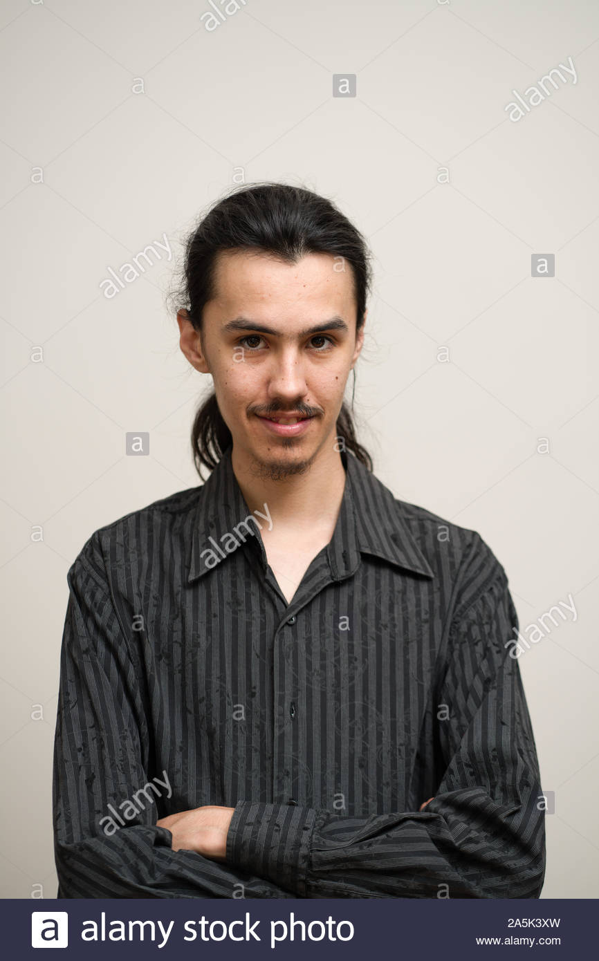 Long Haired Man With A Mustache And Ponytail Wearing A Black