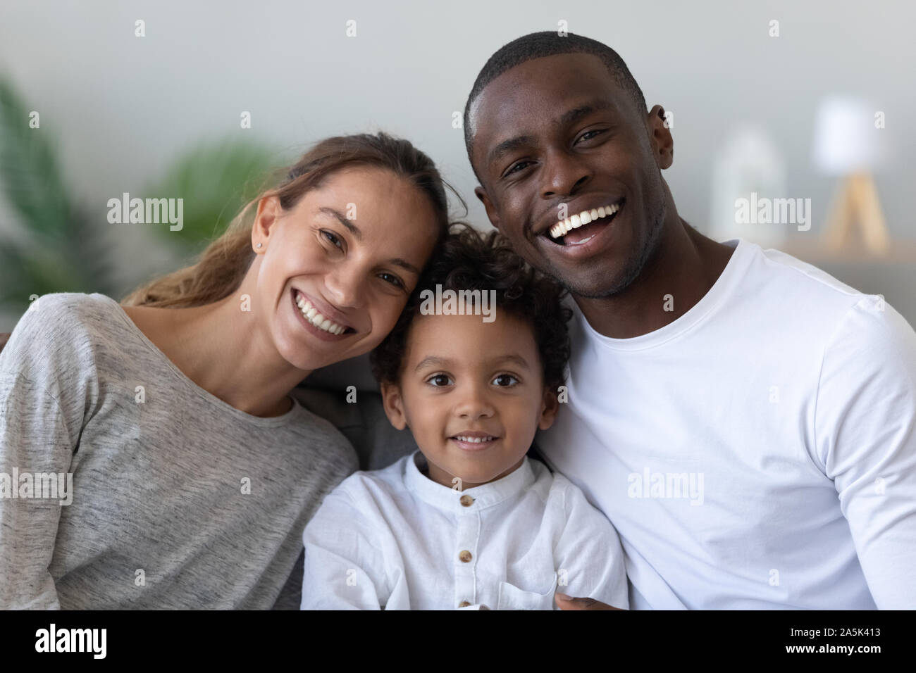 Portrait of happy multiracial family with little biracial son Stock Photo Alamy