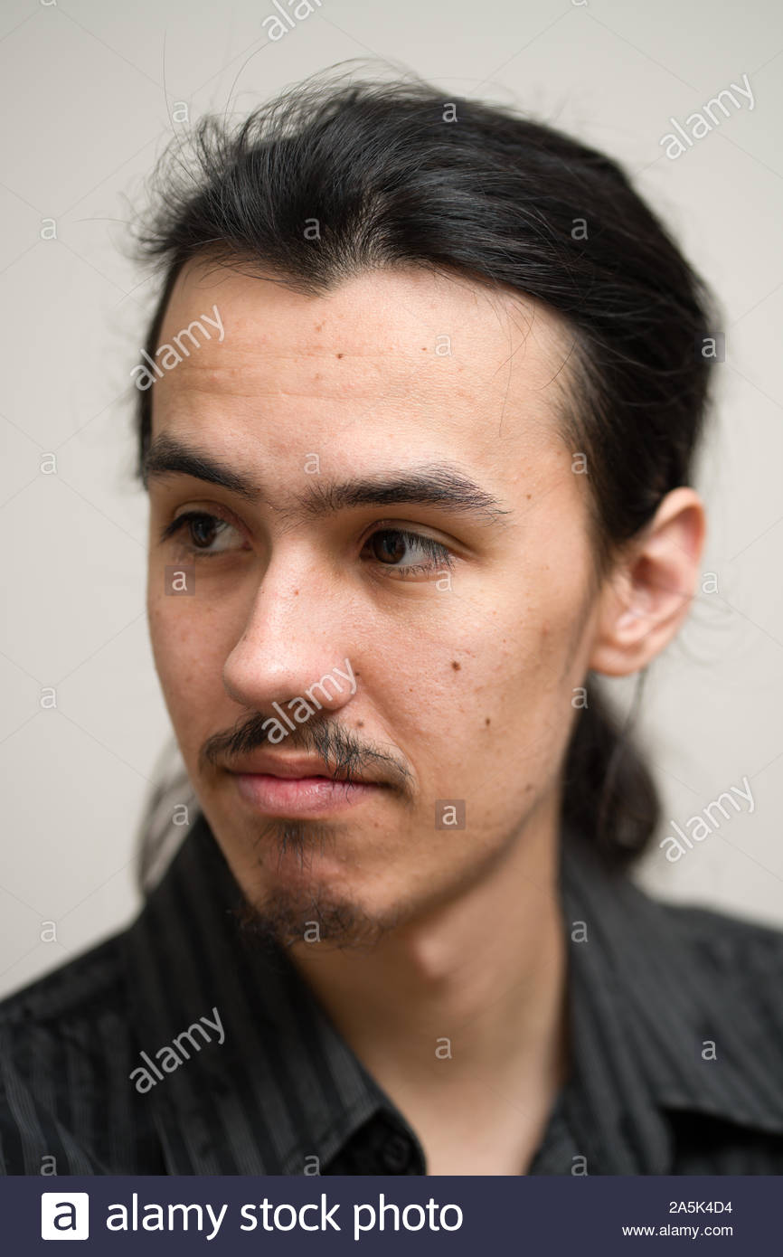 Long Haired Man With A Mustache And Ponytail Wearing A Black