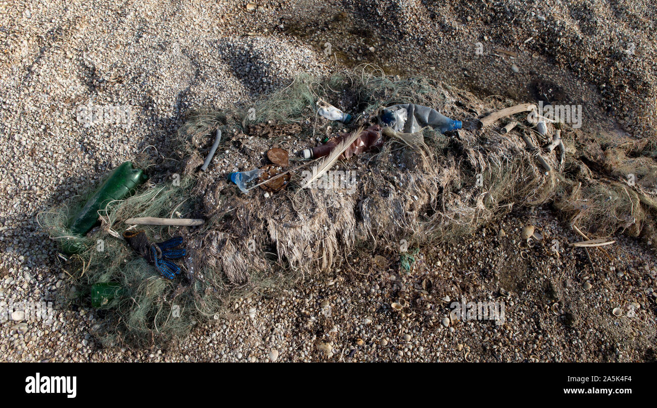 Fishing net full of garbage, wastes and trash on seaside Stock Photo ...