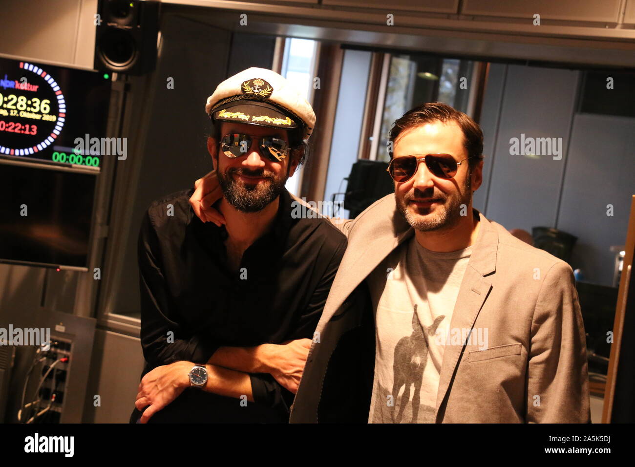 HANDOUT - 17 October 2019, Hamburg: "Pascal van der Straaten" alias Pascal Strehler (l) and "Francesco Fragile" alias Robert Hauspurg stand in a recording studio. The two Hamburgers want to start with a trashy anthem for San Marino at the Eurovision Song Contest 2020. Pascal Strehler, author at NDR Kultur, and Robert Hauspurg, presenter at Bremen Zwei, have already finished their song entitled "San Mariyes - San Marino", according to the homepage of the Eurovision Song Contest (ESC). Under their artist identities Pascal van der Straaten and Francesco Fragile they had applied to the San Marino Stock Photo