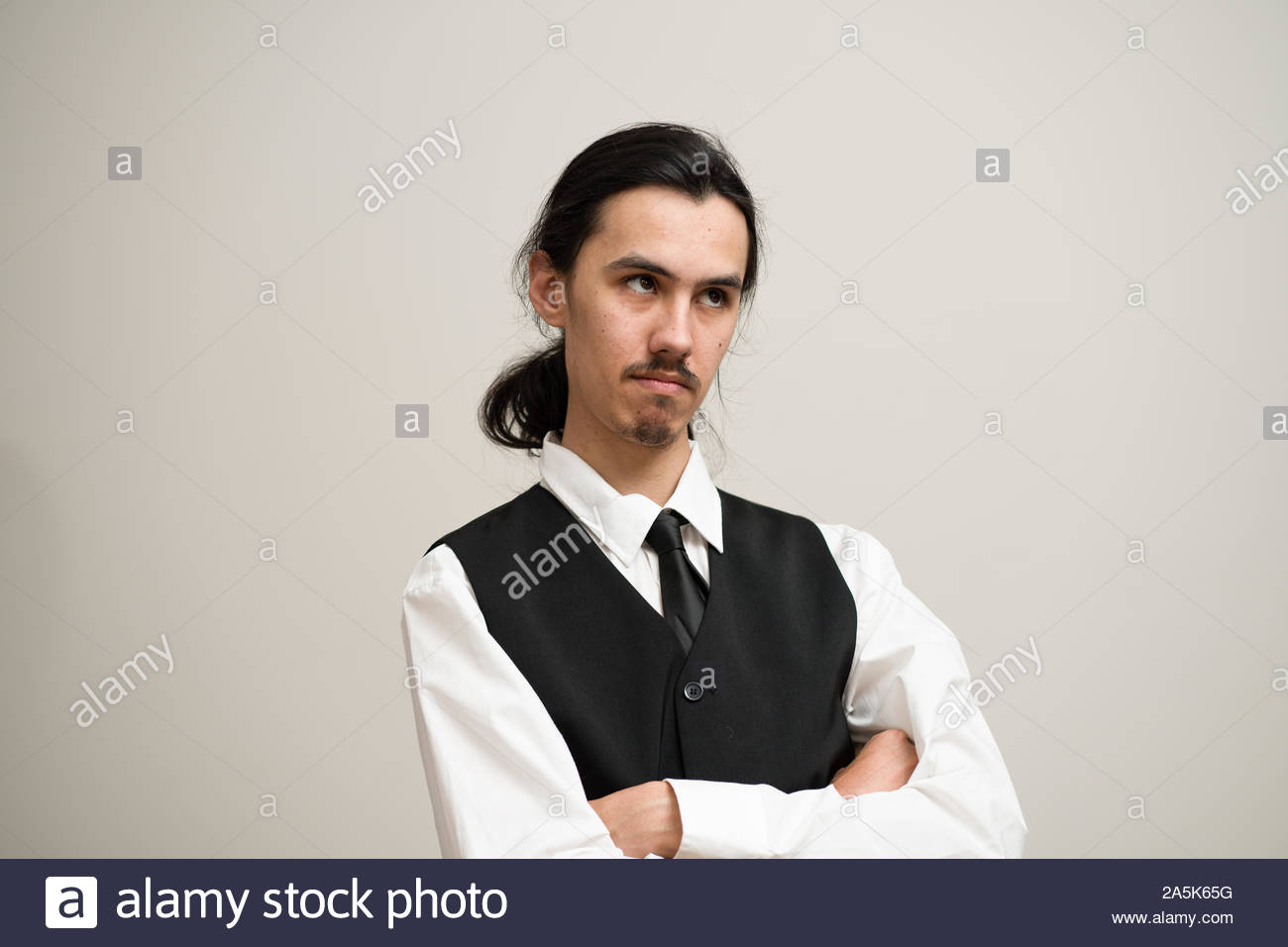 Long Haired Man With A Mustache And Ponytail Wearing A White