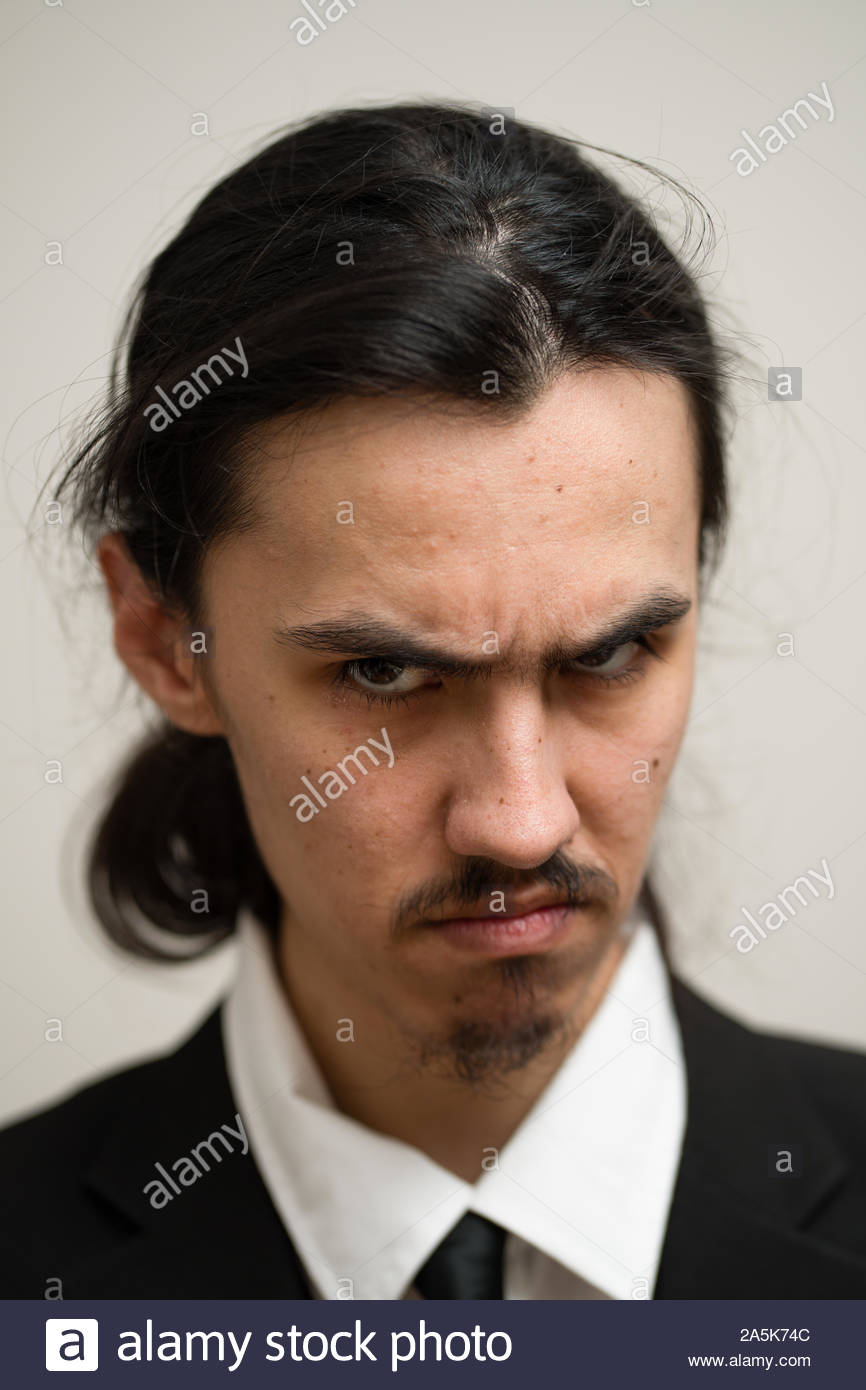 Long Haired Man With A Mustache And Ponytail Wearing A Black