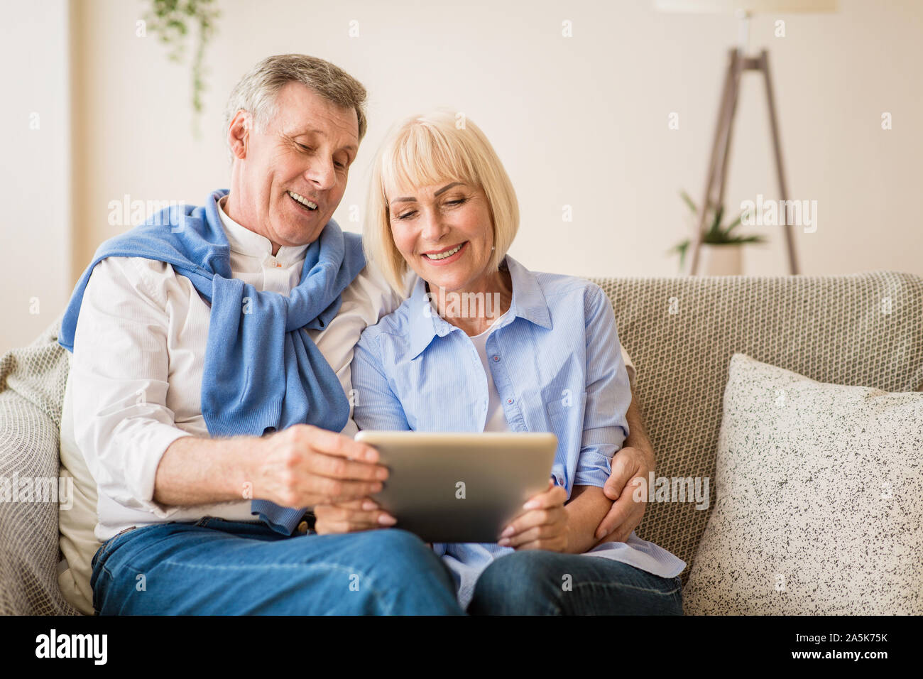 Surfing internet. Mature couple using digital tablet Stock Photo