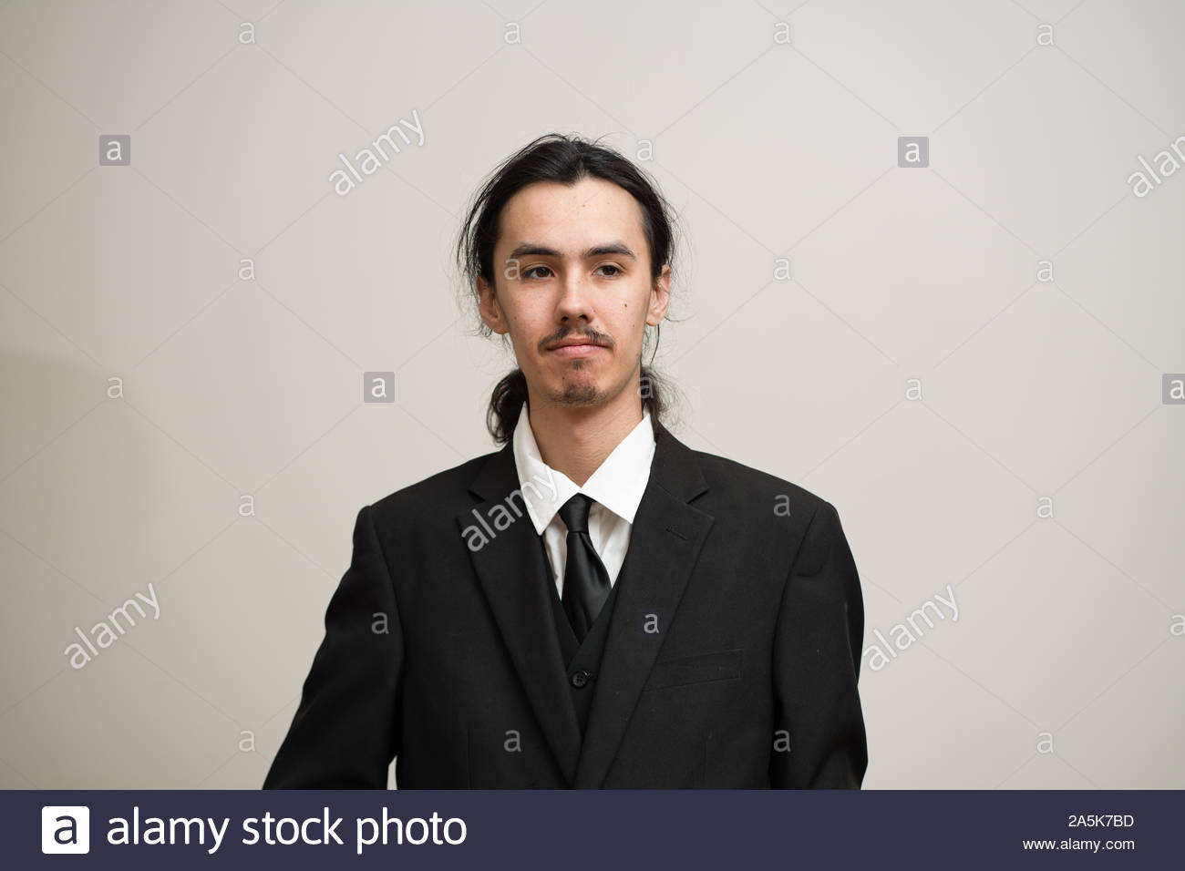 Long Haired Man With A Mustache And Ponytail Wearing A Black