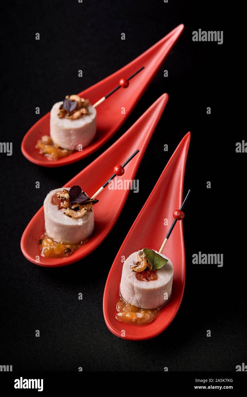 Goose liver pate, foie gras, served on black stone in Japanese red