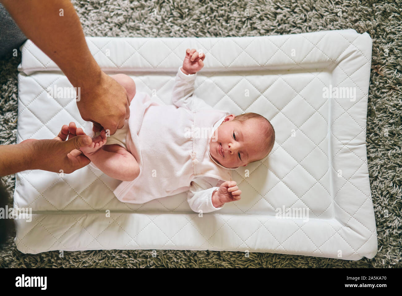 Father changing baby's diaper at home Stock Photo