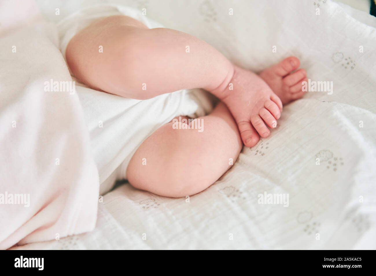 Baby lying down on U-shaped pillow Stock Photo