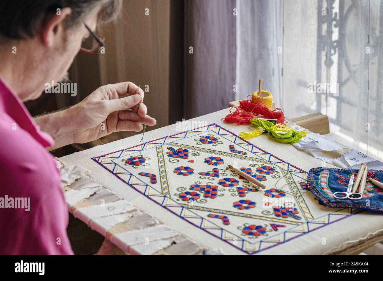 Craftsman busy with needlework indoors, ÎledeFrance, Paris Stock