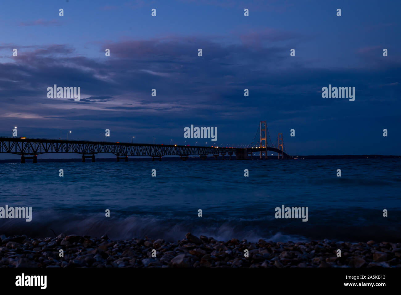 Colored lights decorate the Mackinac Bridge spanning the Straits of Mackinac between the upper and lower peninsulas of Michigan, USA. Stock Photo