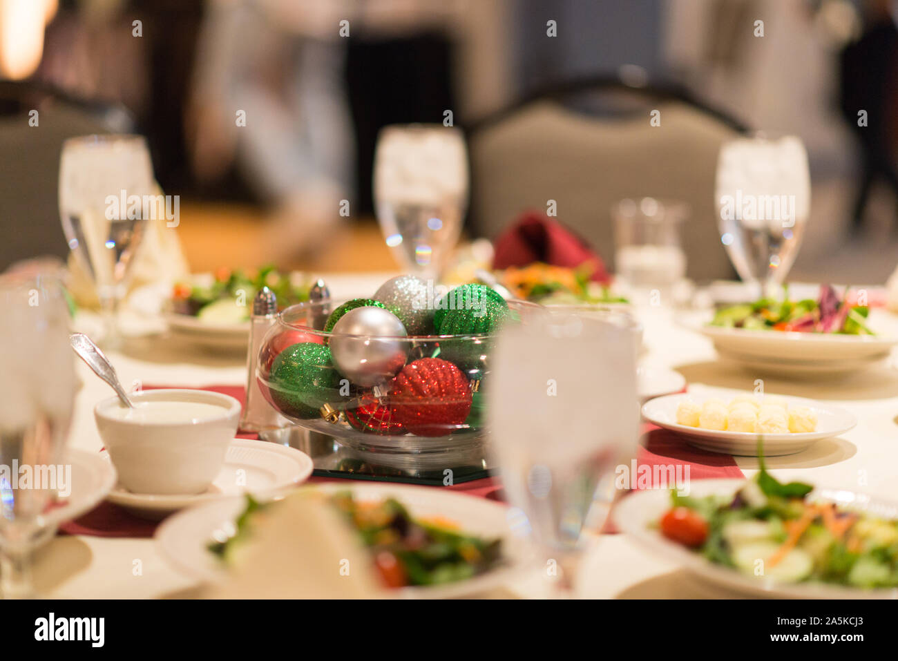 Christmas table setting with salads and ornament centerpiece Stock Photo