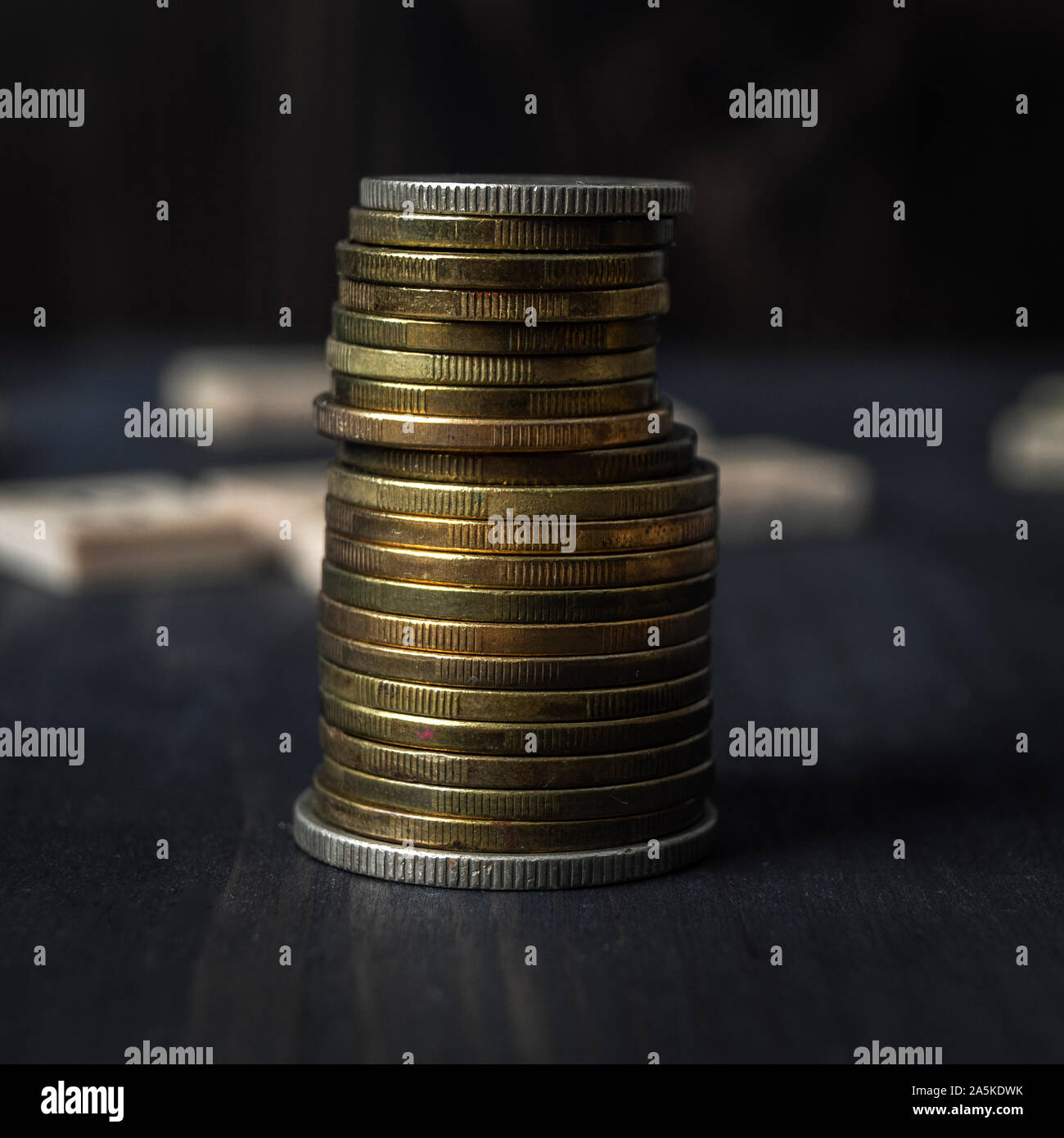 Stucks of coins on the wooden table, close up Stock Photo