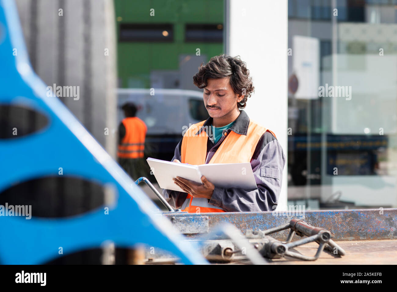 Male engineer on construction site writing in notebook Stock Photo