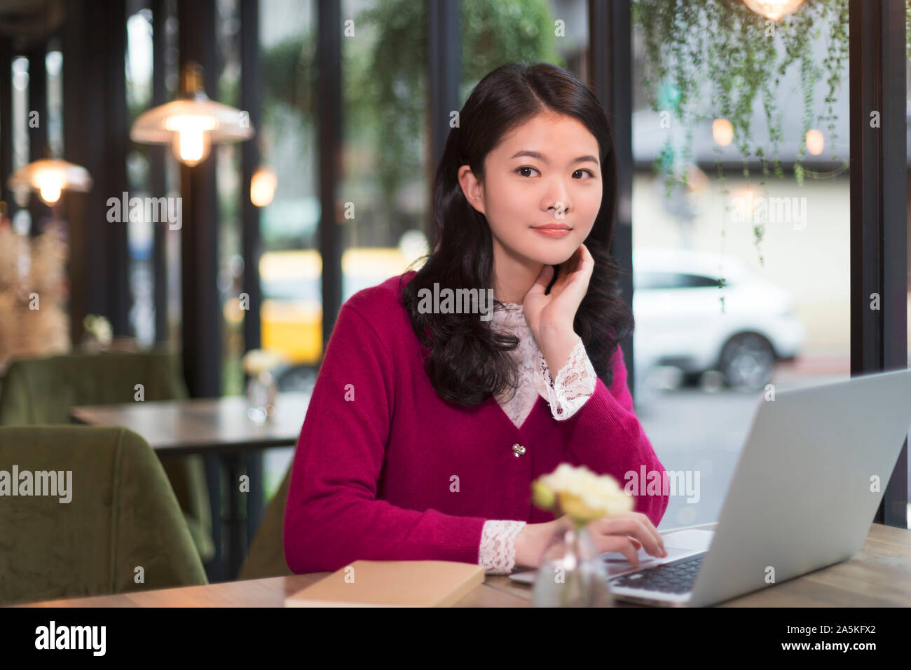 Woman working on laptop in cafe Stock Photo