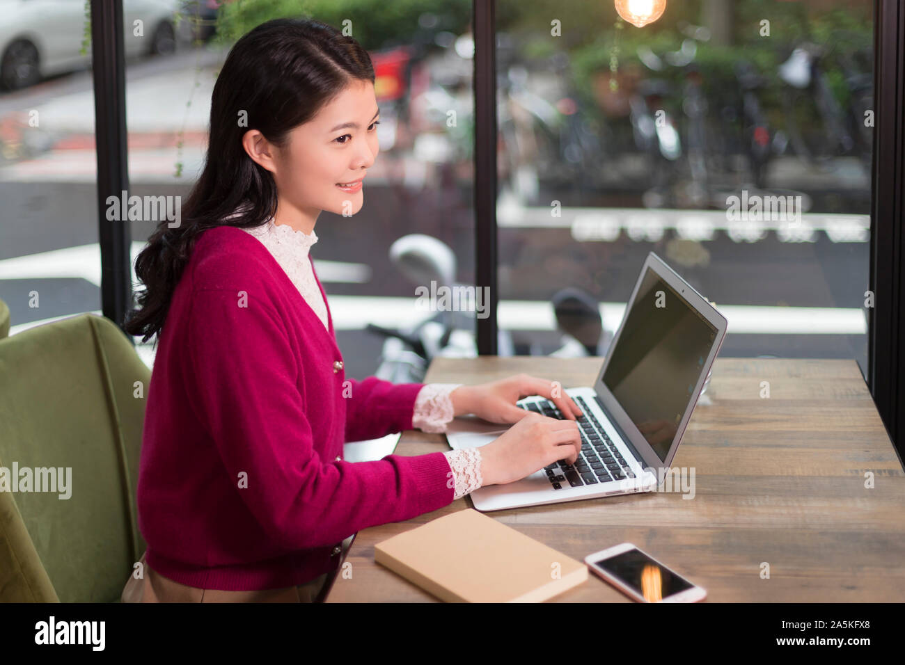 Woman working on laptop in cafe Stock Photo