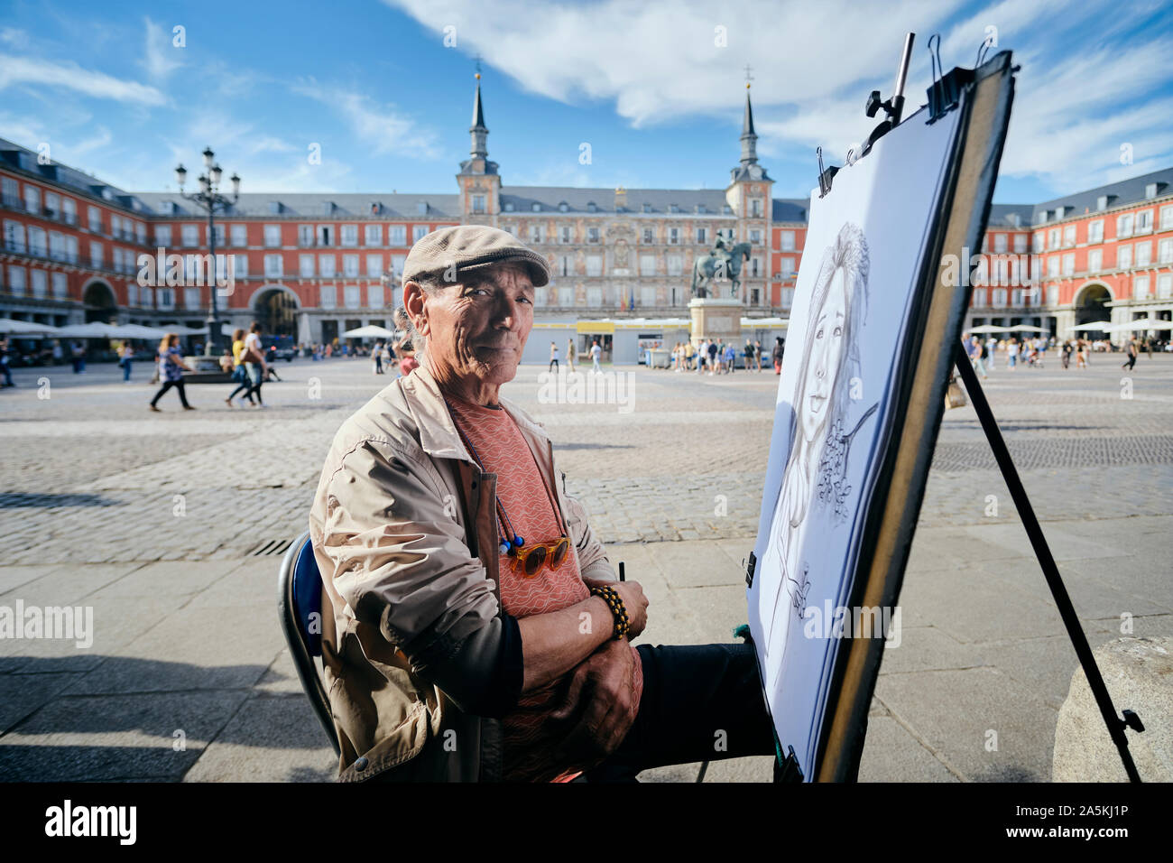 Mature male street artist by drawing canvas in town square, portrait, Madrid,  Spain Stock Photo - Alamy