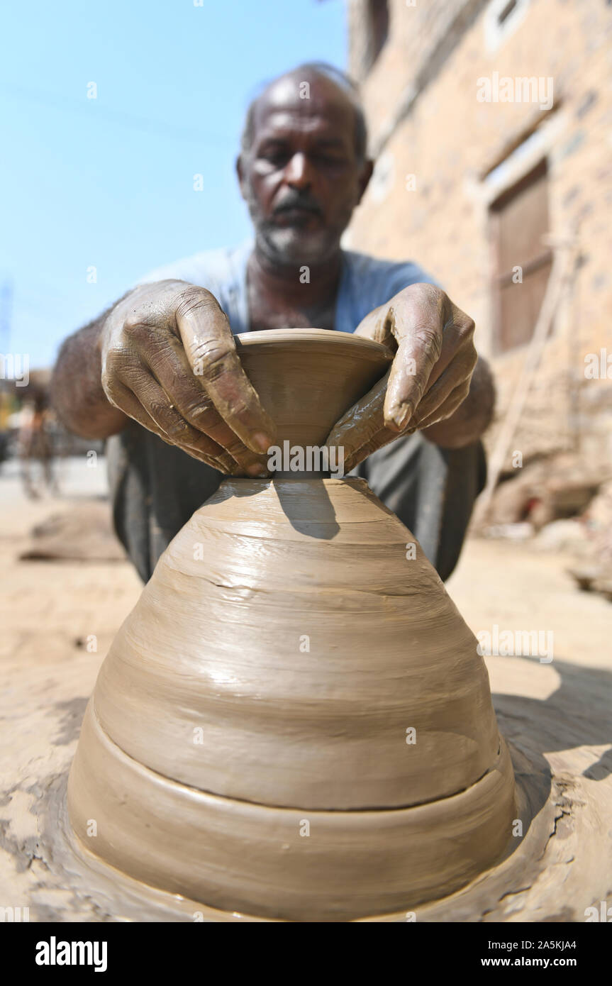 A potter prepares clay lamp or diya on potter's wheel in his residence ahead of Diwali festival in Beawar, Rajasthan. Photo/Sumit Saraswat Stock Photo