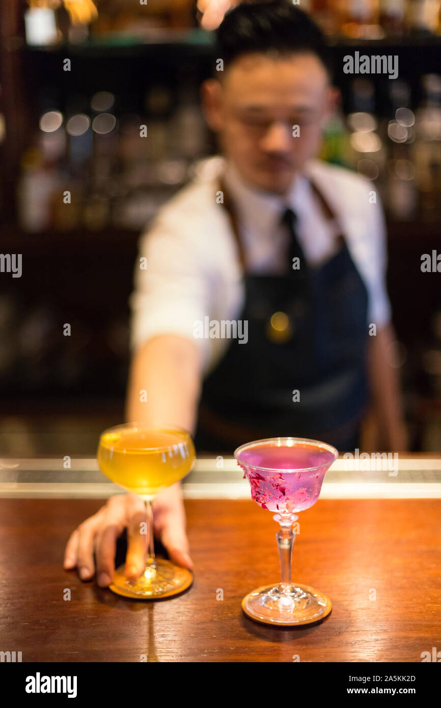 Bartender serving cocktails Stock Photo