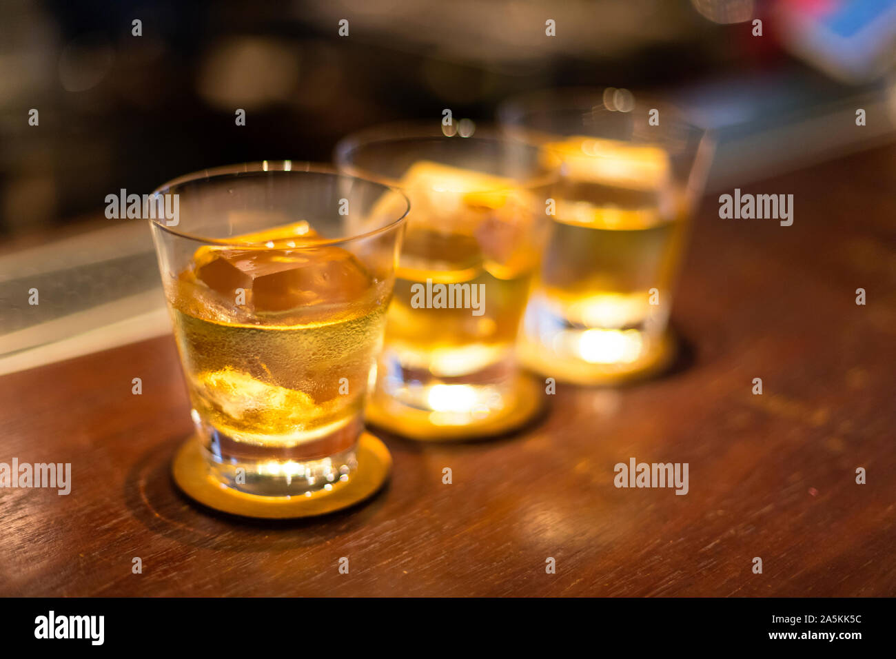Three drinks in a row on bar counter Stock Photo