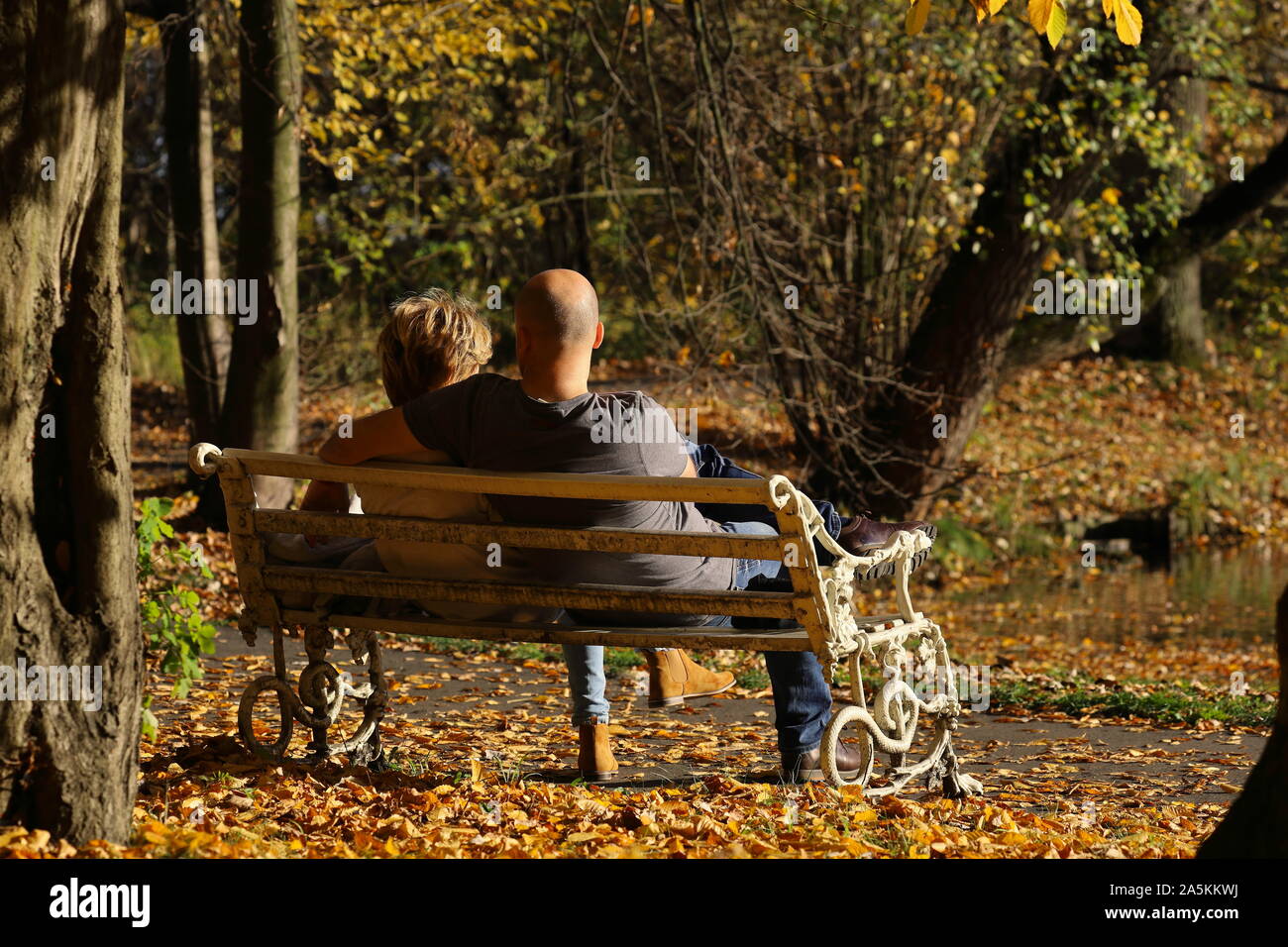 couple sitting on a bench in autumn park Stock Photo