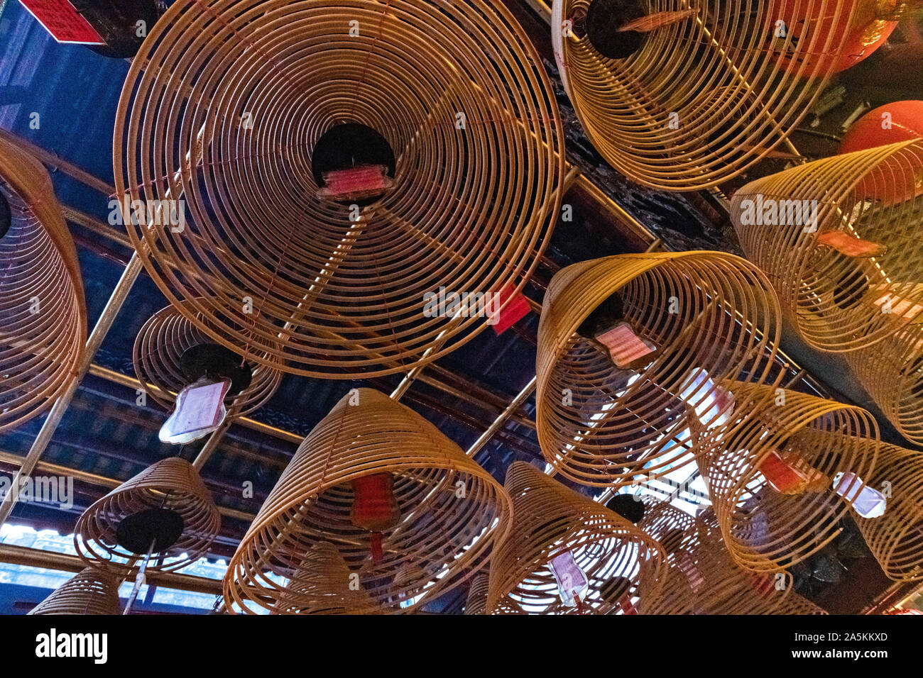 The interior of the Man Mo Temple with giant hanging incense coils ...