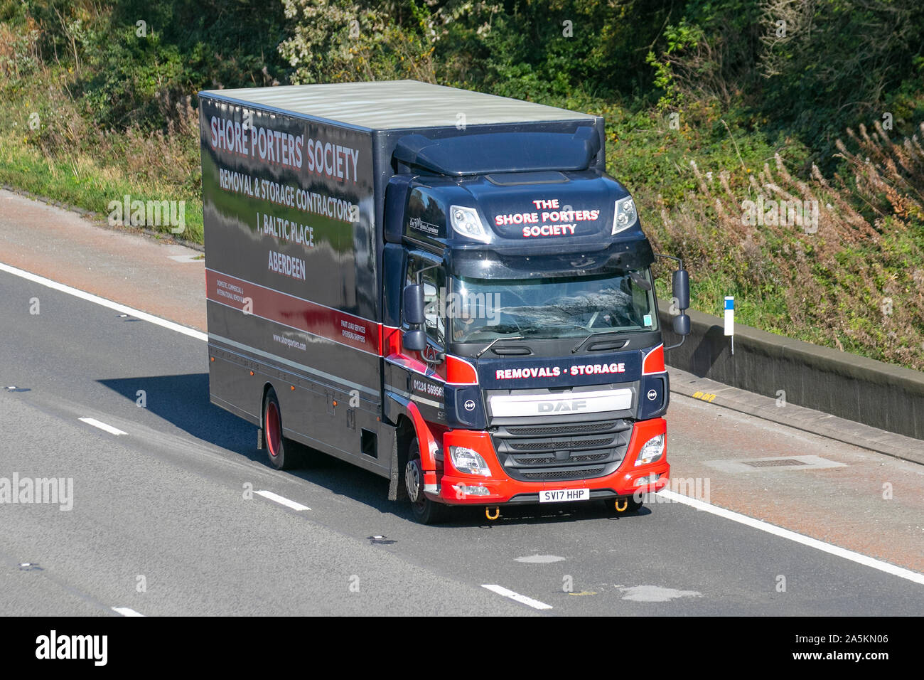 The Shore Porters Society Aberdeen; Haulage delivery trucks, haulage, lorry, transportation, truck, cargo, DAF CF vehicle, delivery, transport, industry, supply chain freight, on the M6 at Lancaster, UK Stock Photo