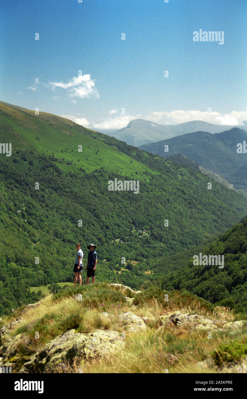 Two children admire the view, Port de Lers, Ariège, Occitanie, France: view back down the Suc valley in the Pyrénées.  MODEL RELEASED Stock Photo