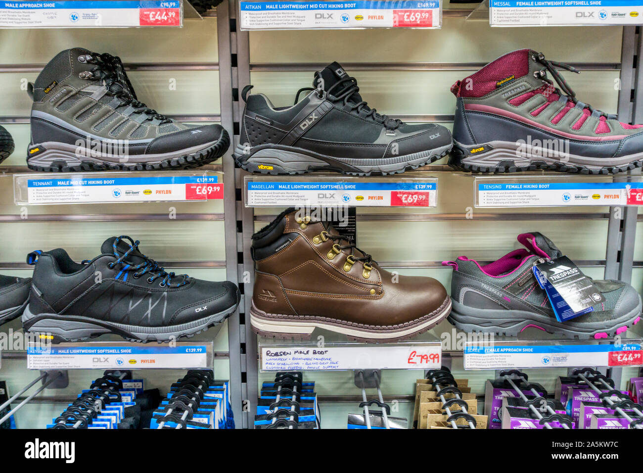 Hiking boots for sale in an outdoor clothing shop. Stock Photo