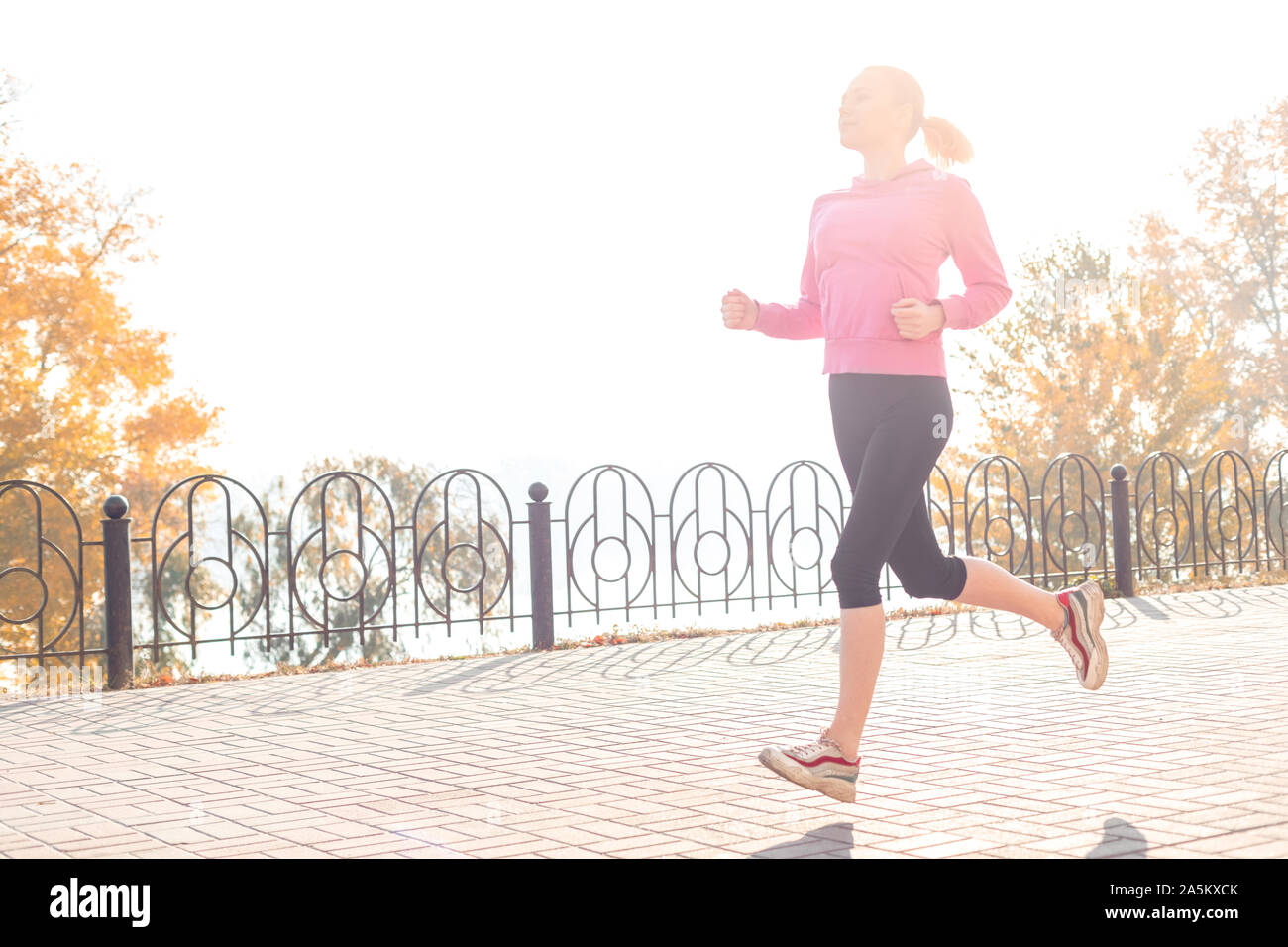 Healthy Lifestyle. Young woman jogging outdoors autumn season in