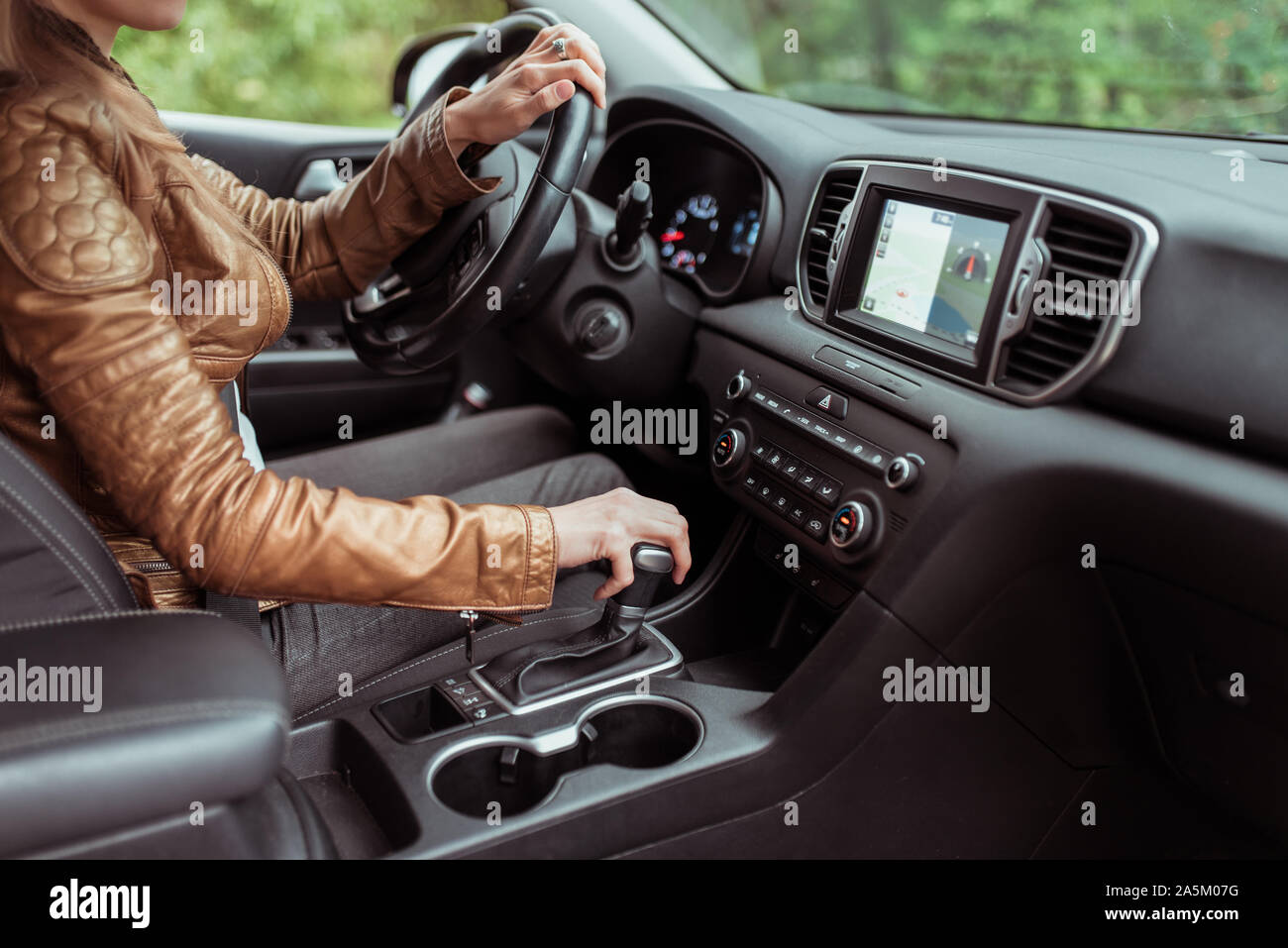 woman in summer autumn, driving car, parking reversing, engages