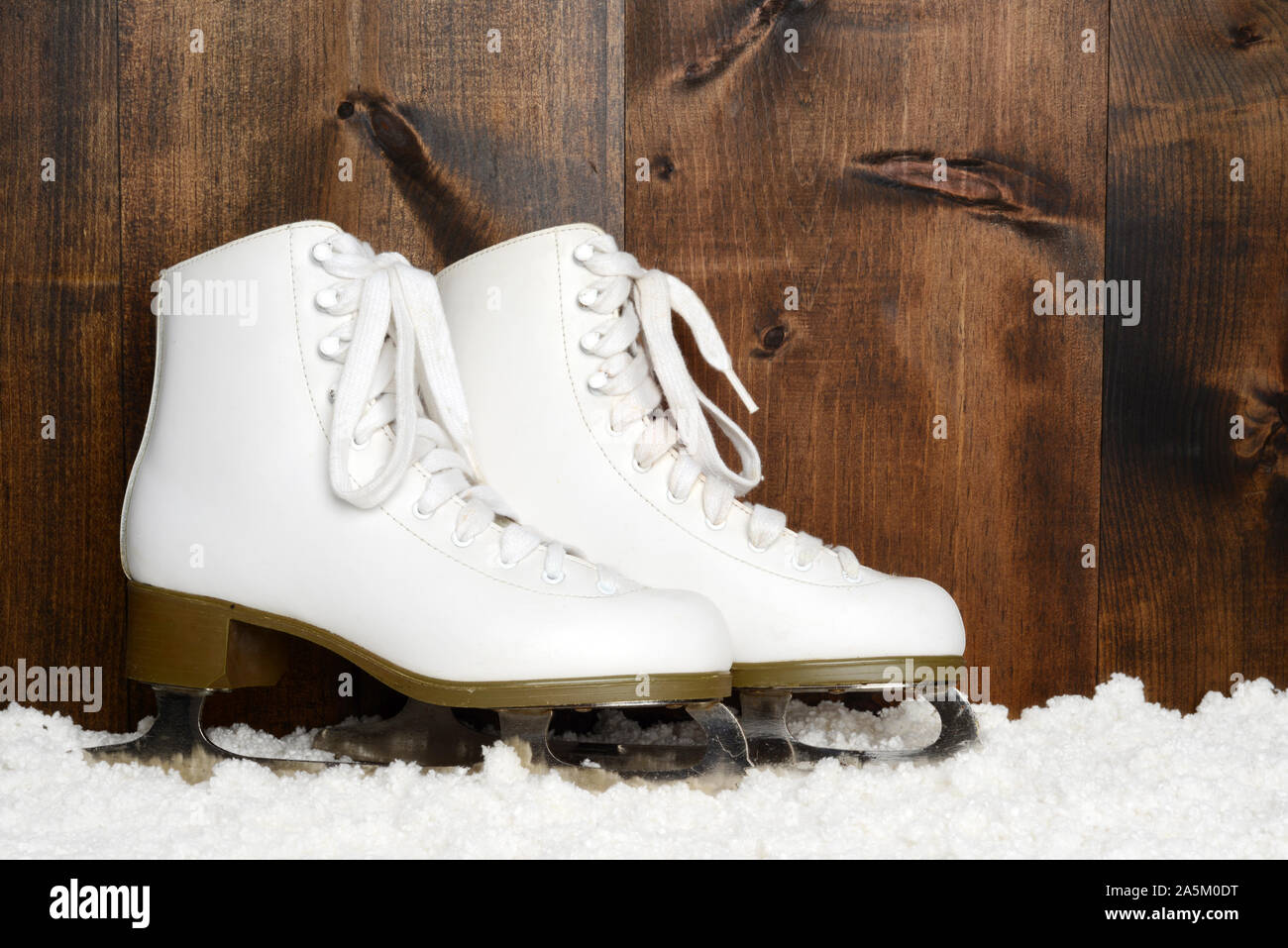 ladies figure skates leaning on wood Stock Photo Alamy
