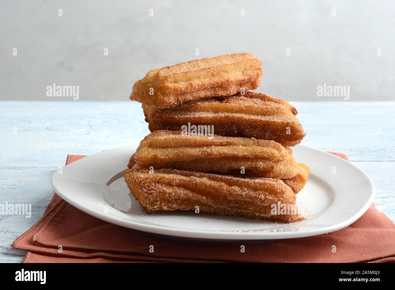 Churros Risers Pile of churros on a plate Stock Photo - Alamy