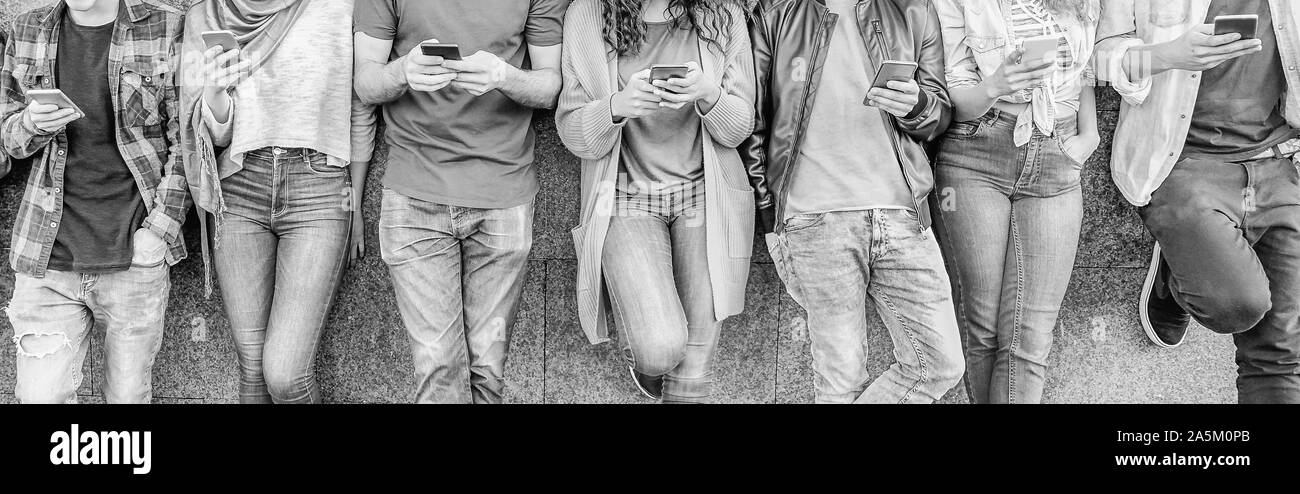 Group of friends using their smart mobile phones - Millennial young people addicted to new technology trends app Stock Photo