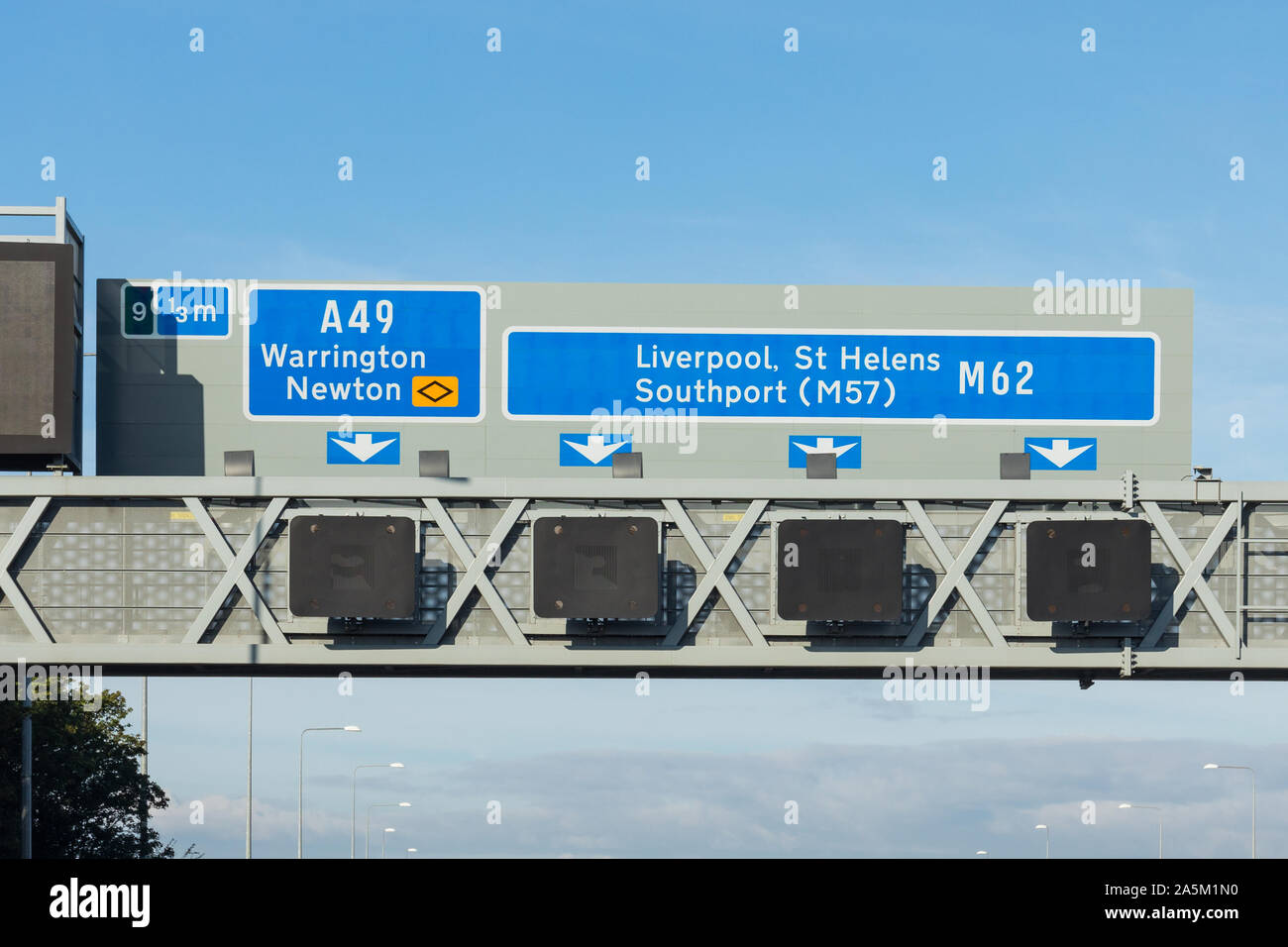 UK motorway sign showing directions to A49 Warrington, Newton and M62 Liverpool, St Helens, Southport (M57) Stock Photo