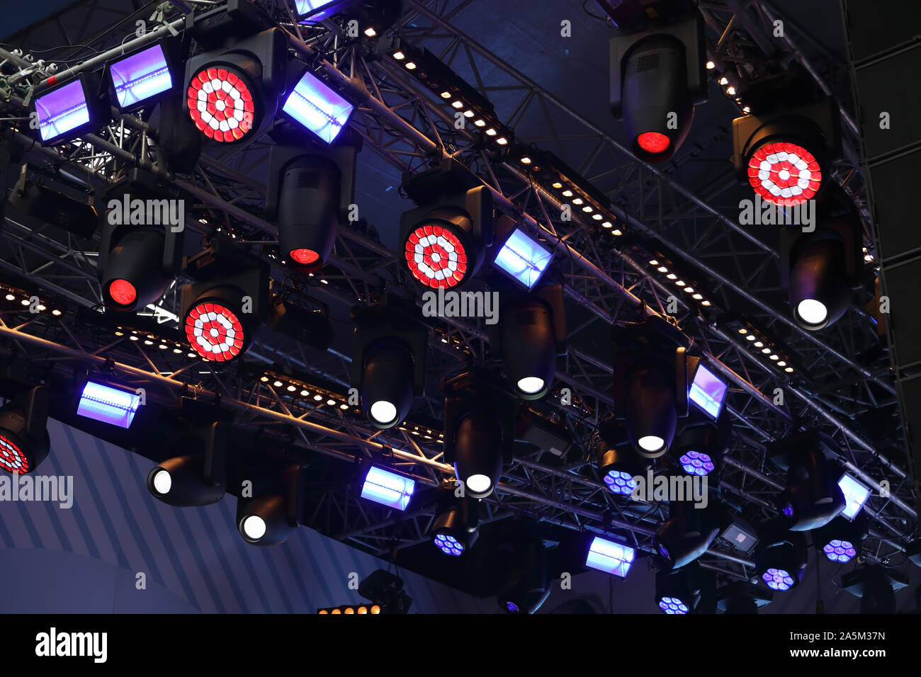 Moving heads and another stage light fixtures hanging on truss. Stock Photo