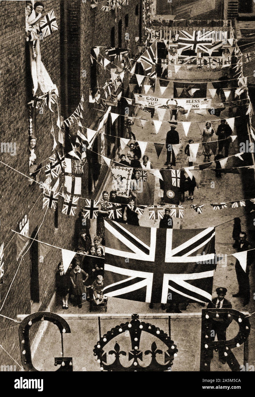 1937 photograph taken during the coronation of King George VI of Britain. - Decorated street in preparation for a street party celebration in London Stock Photo