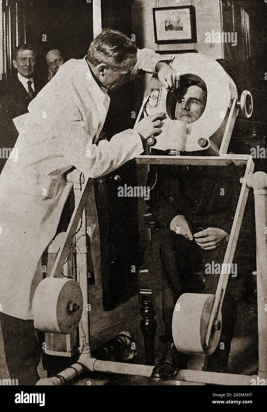 1940's - Removing a metal splinter from a patients eye with a medical electro magnet Stock Photo