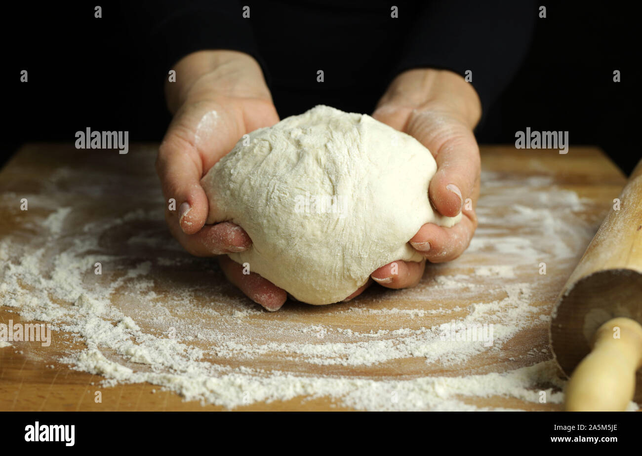 Preparing Traditional Homemade Dough Close Up View Of Woman Hands Kneading Fresh Dough For Making Bread Or Pizza On A Floured Table Stock Photo Alamy