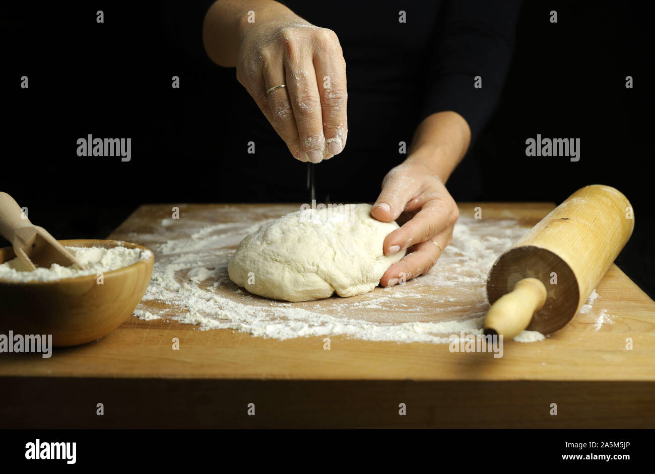 Preparing Traditional Homemade Dough Close Up View Of Woman Hands Kneading Fresh Dough For Making Bread Or Pizza On A Floured Table Stock Photo Alamy