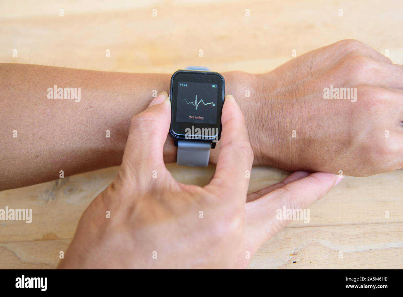 Check ECG by smartwatch / Check Heart rate by Smartwatch Stock Photo