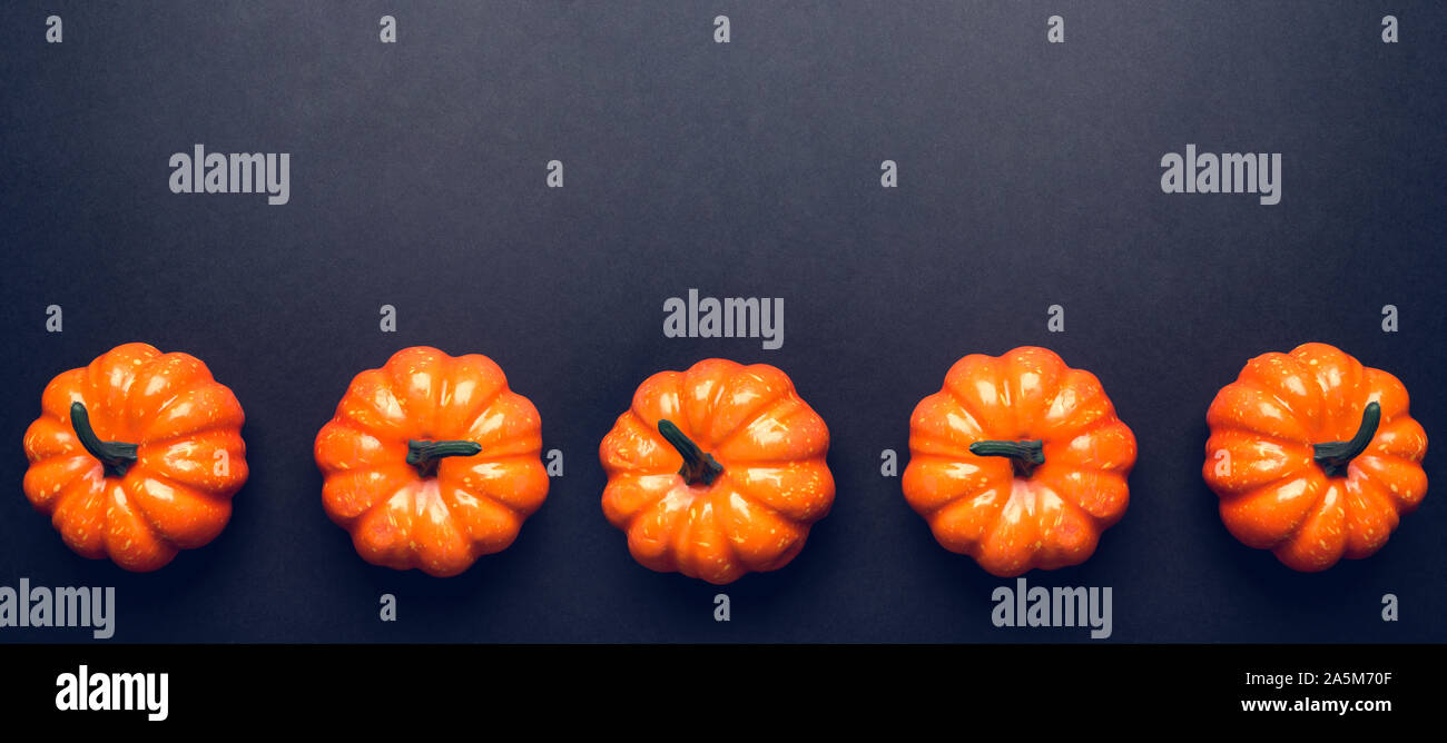 Dark background with three pumpkins Stock Photo - Alamy