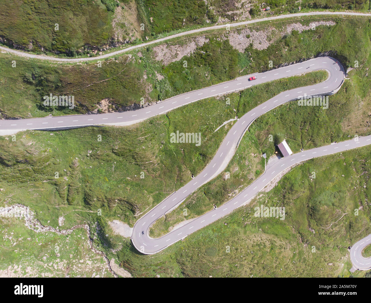 A winding and twisting road through the Swiss mountains Stock Photo