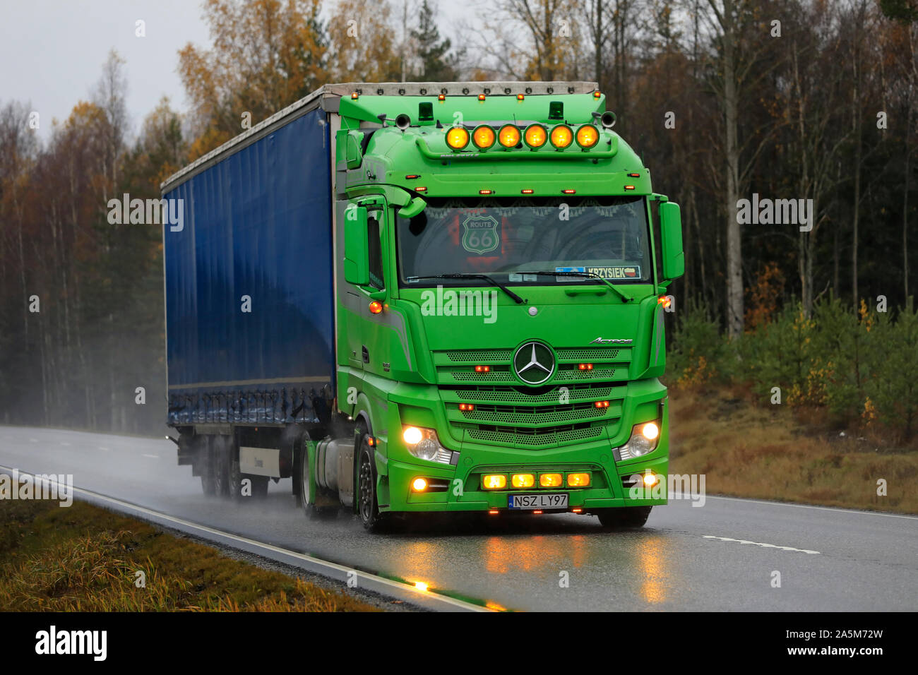 Lime green Mercedes-Benz Actros freight truck from Poland with beautiful light accessories trucking in Tenhola, Finland. October 18, 2019 Photo - Alamy