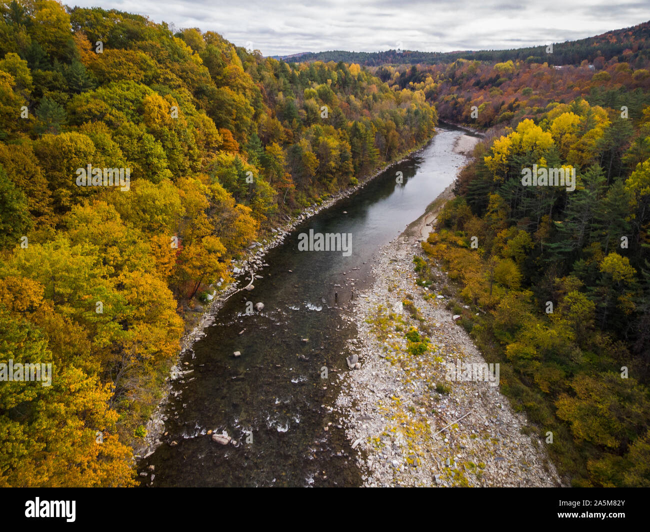 Fall foliage lines the White River in Vermont. Stock Photo