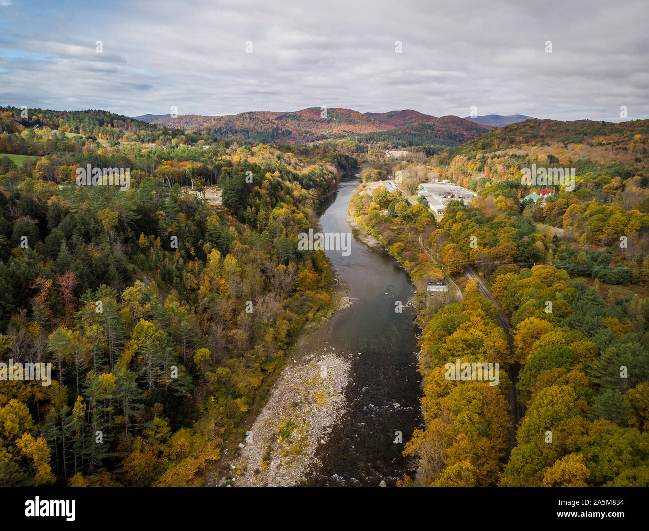 Fall foliage lines the White River in Vermont. Stock Photo