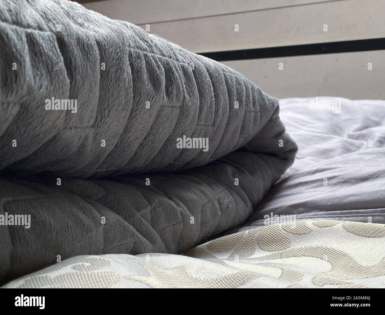Still life of gray, weighted, blanket in bedroom Stock Photo Alamy
