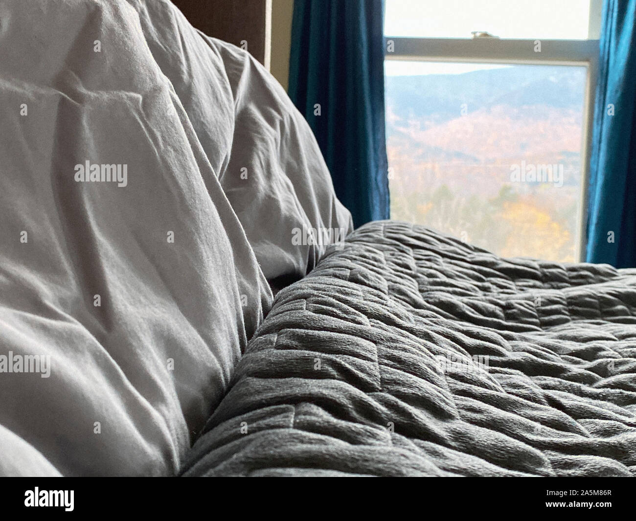 Still Life Of Gray Weighted Blanket In Bedroom Stock Photo