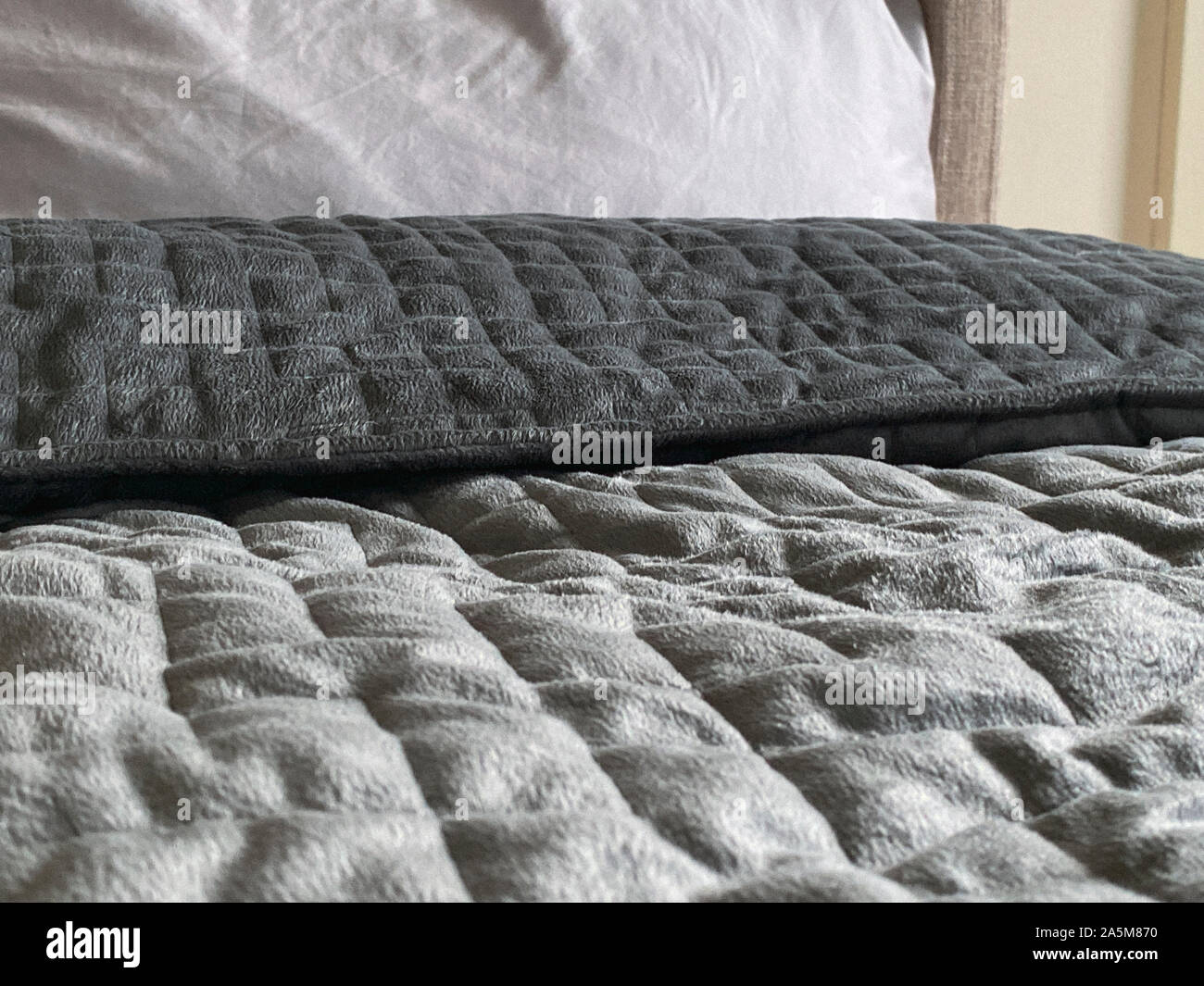 Still life of gray, weighted, blanket in bedroom Stock Photo Alamy